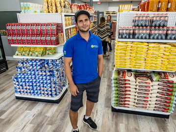 A smiling grocery store worker in Florida
