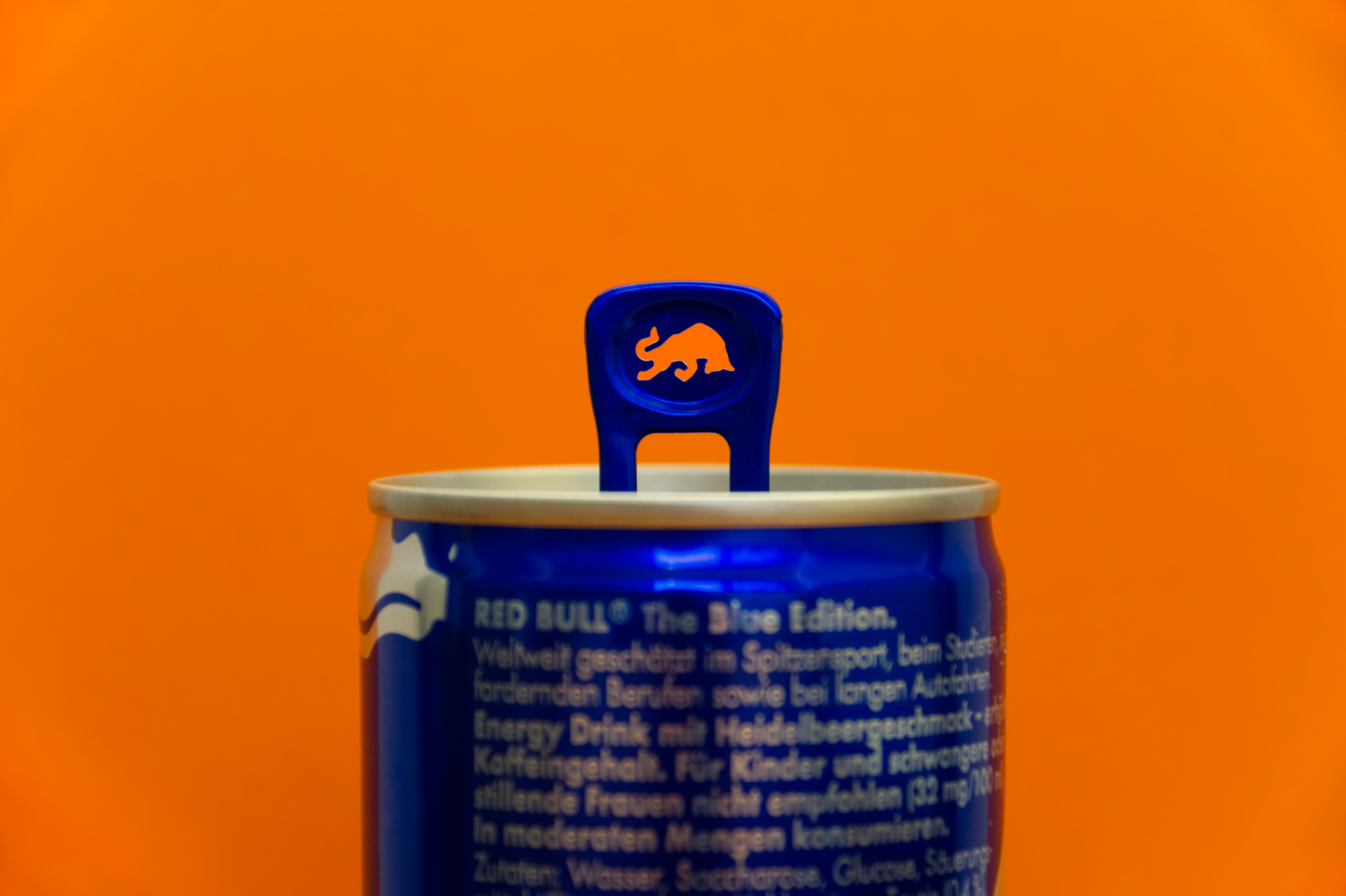 A close-up of Red Bull's can, showing the bull in the ring pull