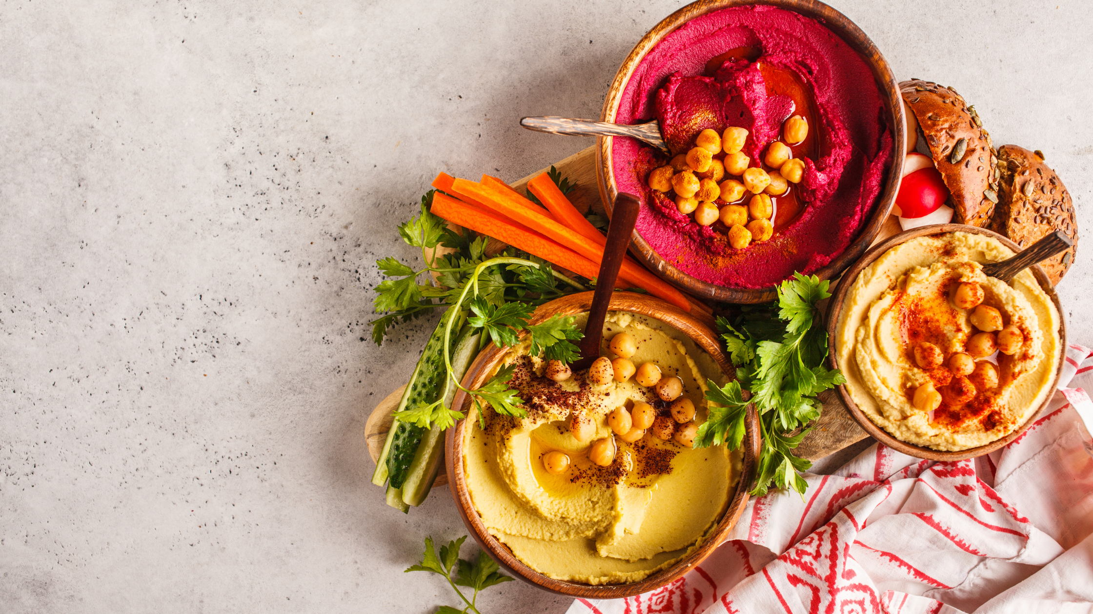 Overhead shot of three bowls of hummus