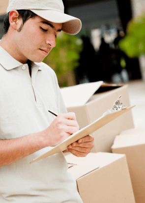 Delivery person signing a document on a clipboard