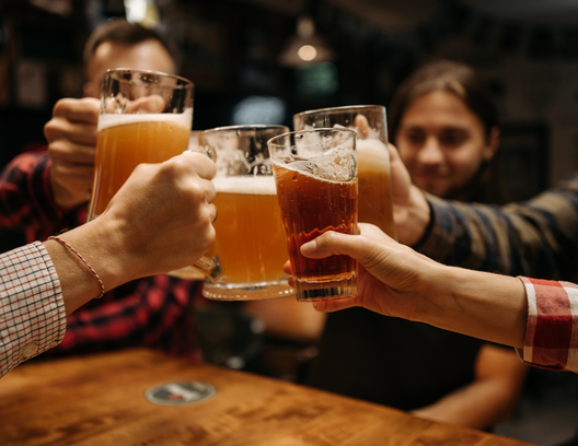 Friends toasting with glasses of beer in a bar
