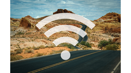 Wifi symbol overlayed on background image of a desert highway