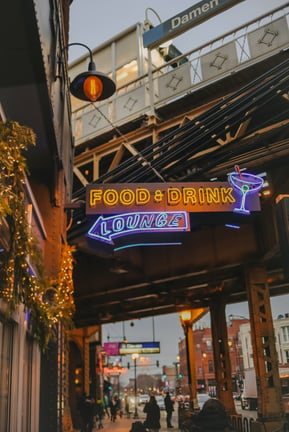 An inner-Illinois city building, with a neon sign that reads 'Food and drink lounge'