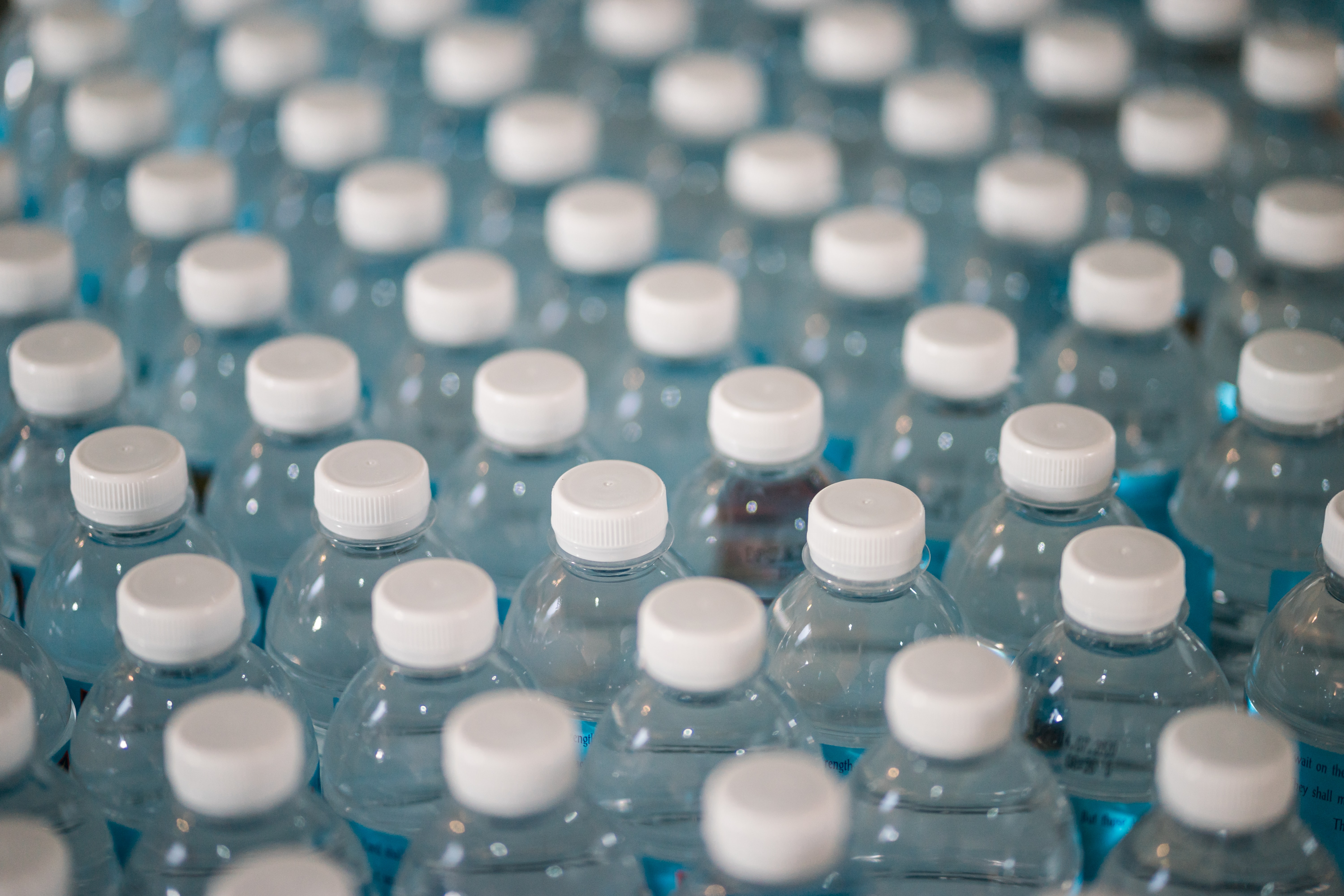 An image of several bottles coming off the production line — Helium and Helium hotspots can help track items as they move through the supply chain