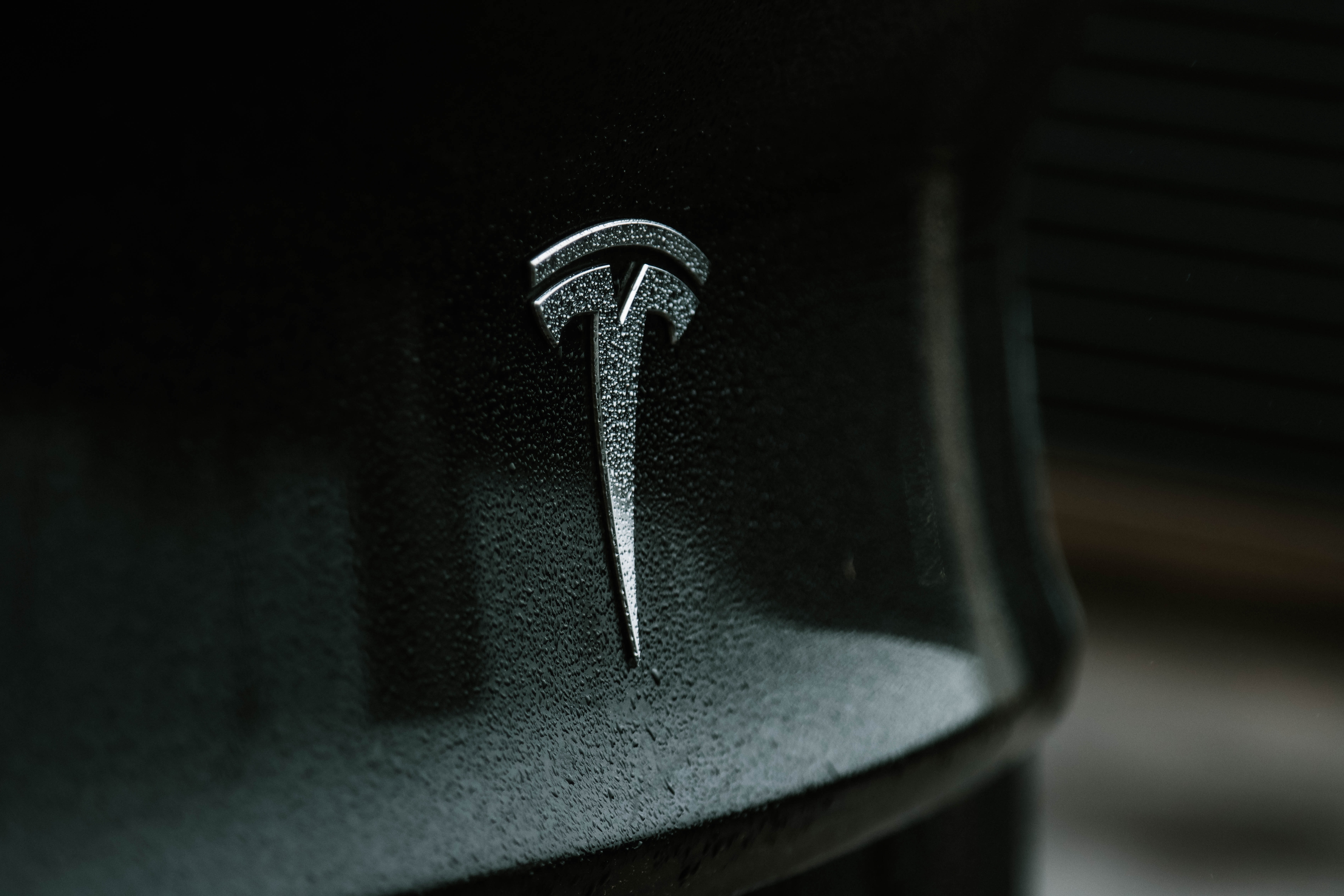 A close-up photo of the Tesla logo