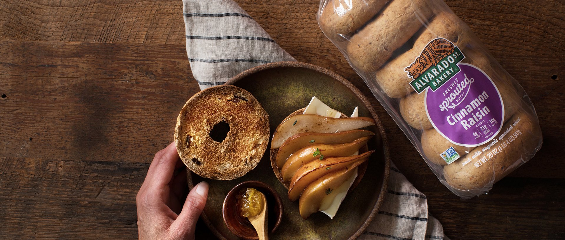 Alvarado Street Bakery Cinnamon Raisin Bagels plated with pear slices and cheese