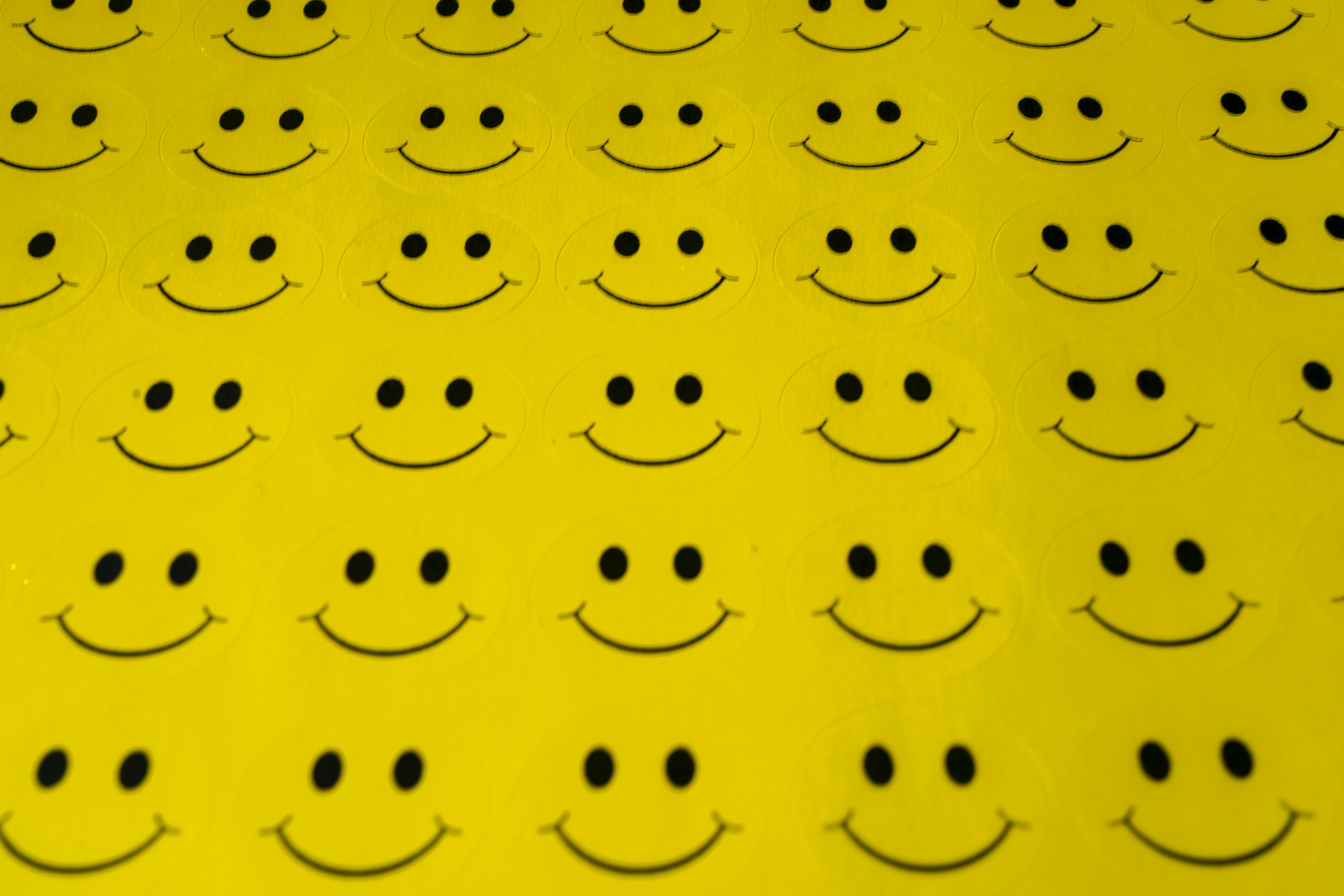 Rows and rows of yellow happy face stickers