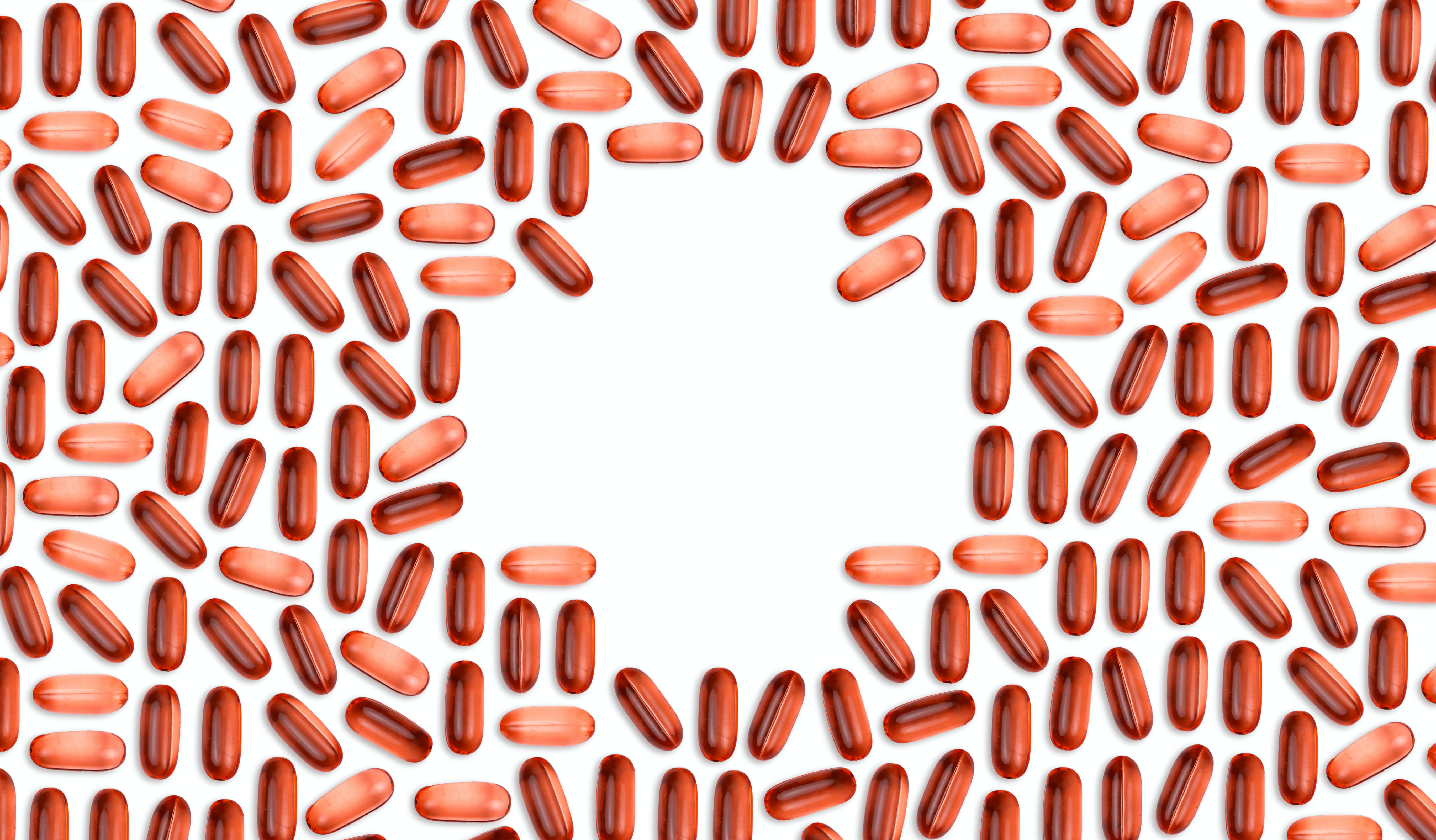 Red vitamins tablets laid out on a table, creating an abstract image