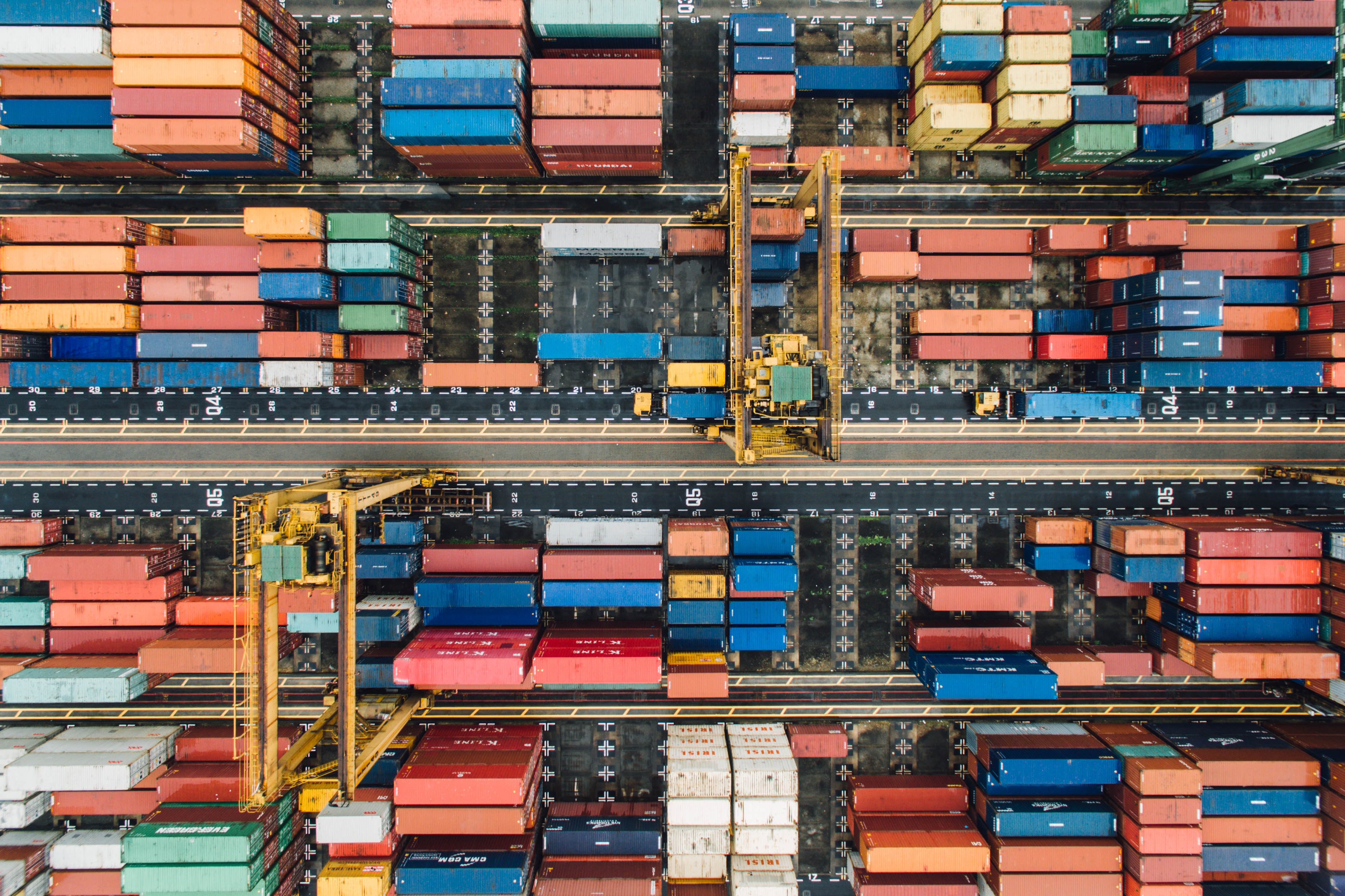 An aerial view of a very busy port, full of containers