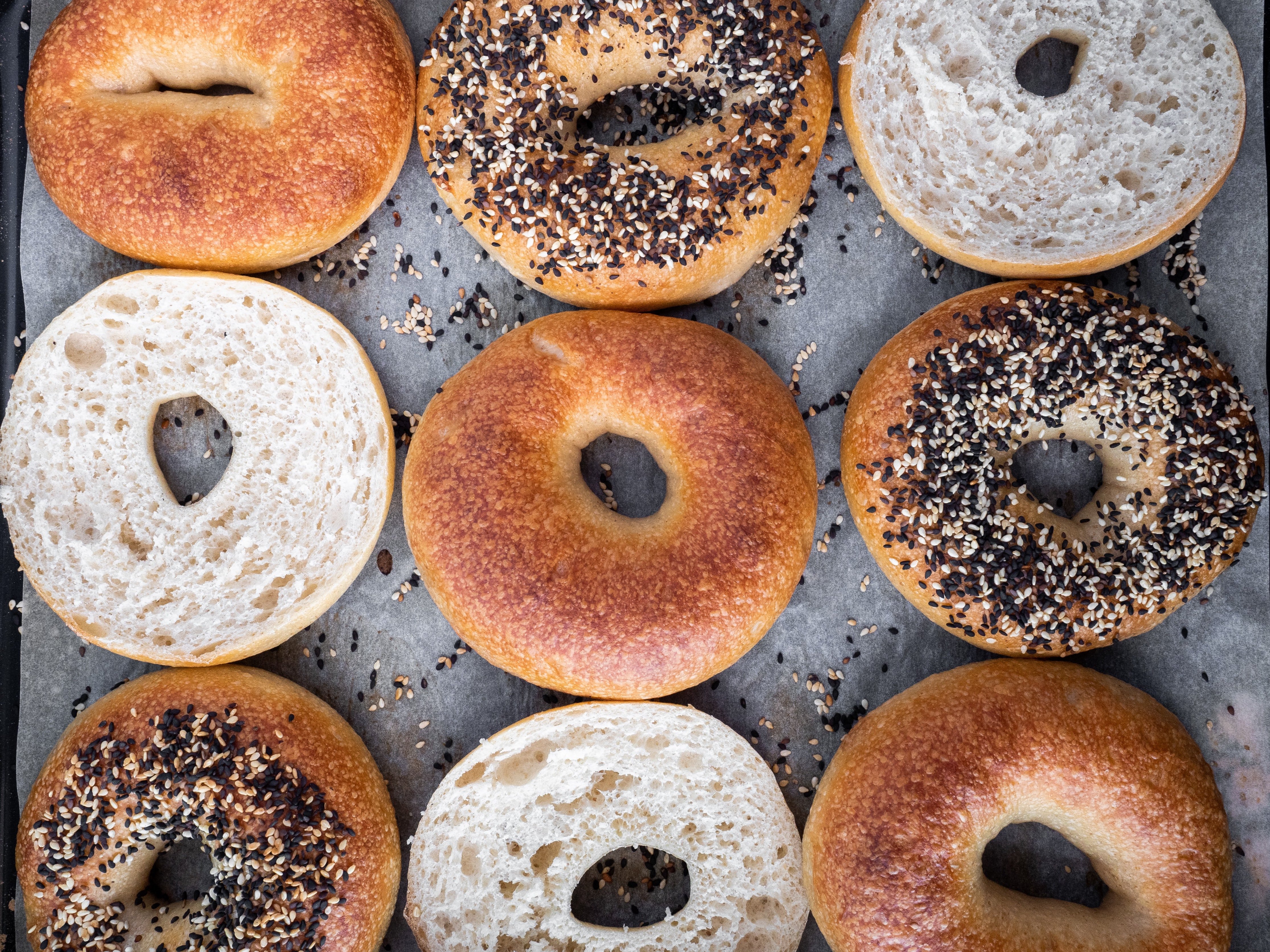 A baking tray of bagels: poppy seed and plain bread