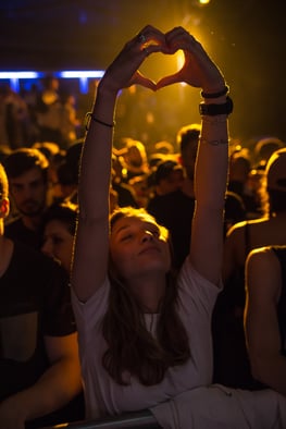 A person making a heart symbol with their hands.