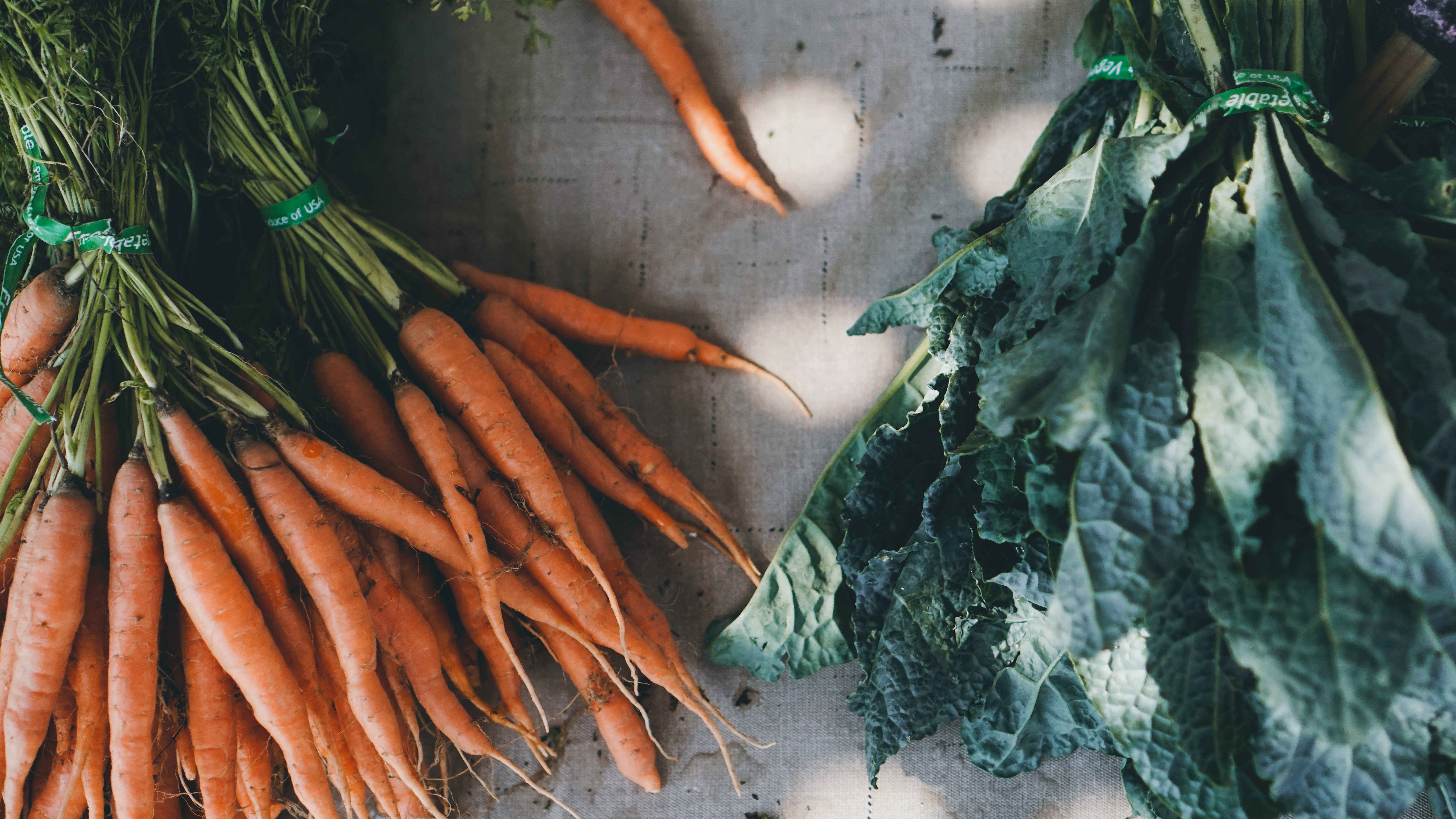 A bunch of carrots and kale.