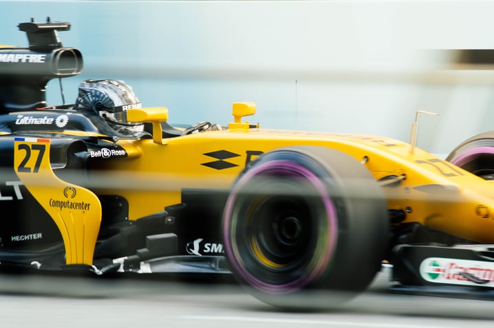 A yellow Formula 1-style racecar during a race