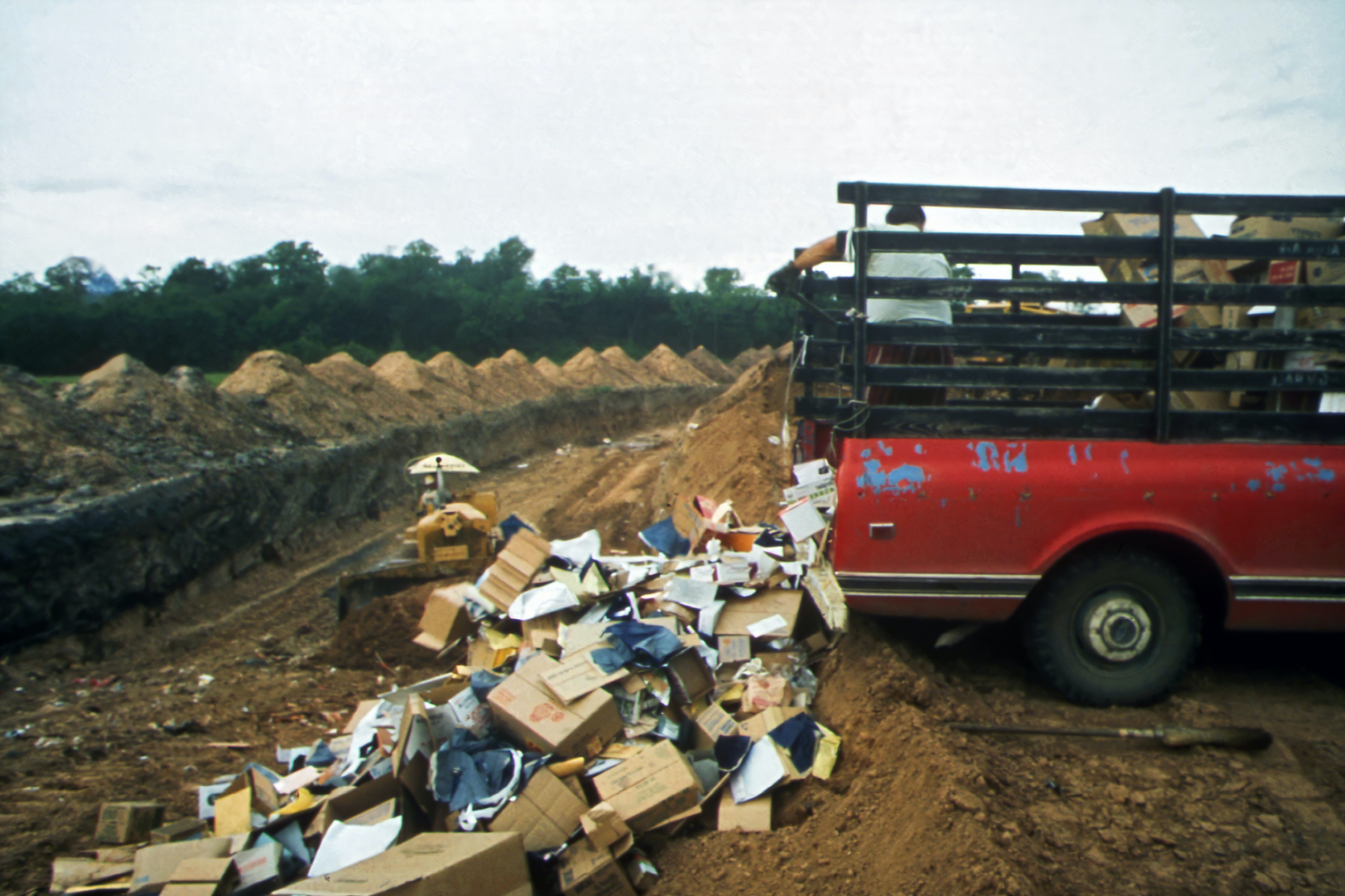 A truck emptying trash.