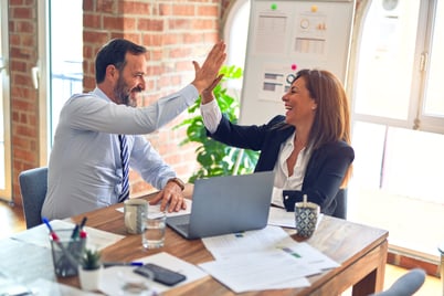 Two colleagues high five.