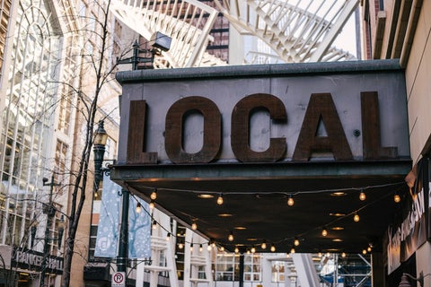 A restaurant sign reading 'Local' in uppercase letters