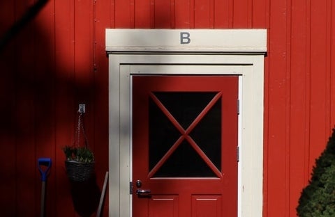 A red barn door with the letter 'B' above it