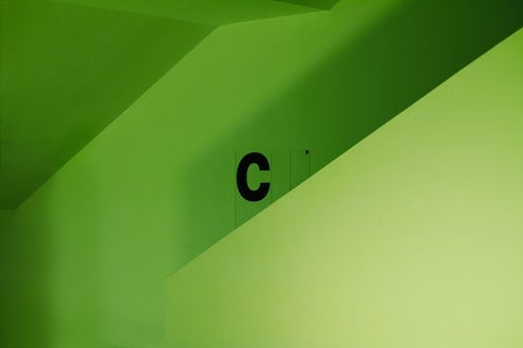 A bright green wall showing the letter 'C'
