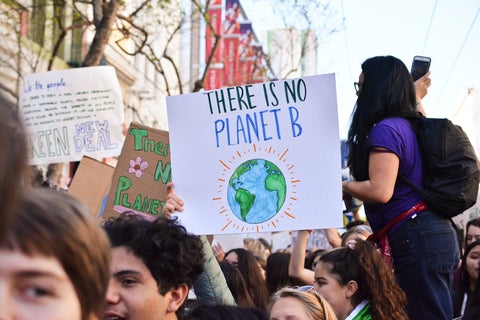 At a climate change rally, someone holds a sign that reads 'There is no Planet B'