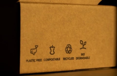 A plain cardboard box that reads "Plastic free, compostable, recycled, biodegradable"