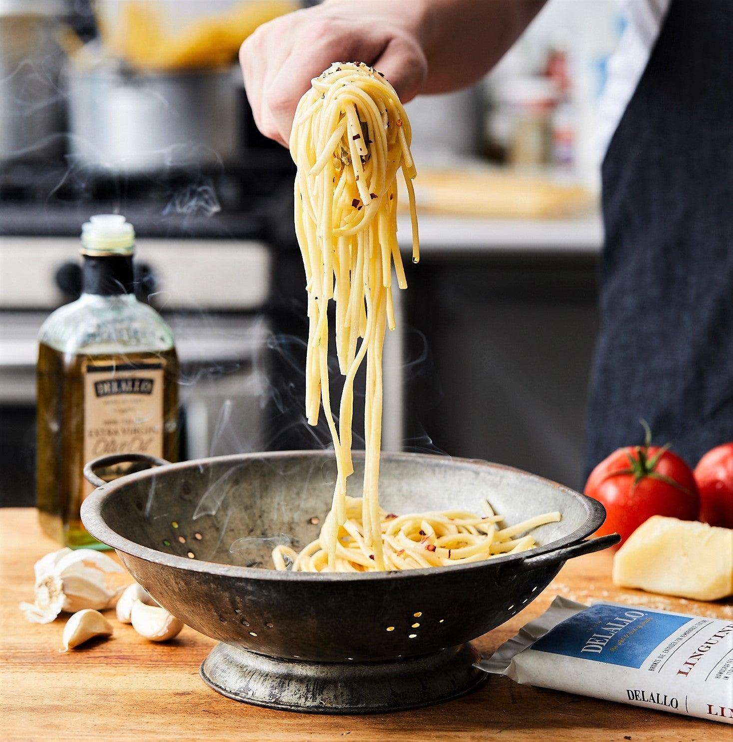 freshly cooked fettucine pasta being served in cozy home kitchen