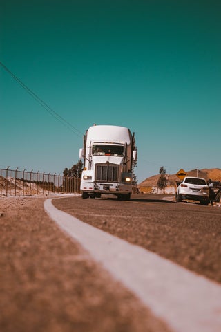 A freight truck drives towards the camera