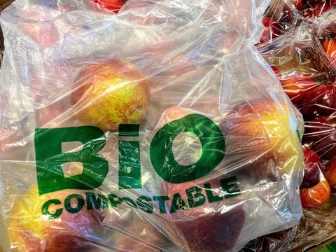 A bag of apples. The bag says "Bio Compostable" on it