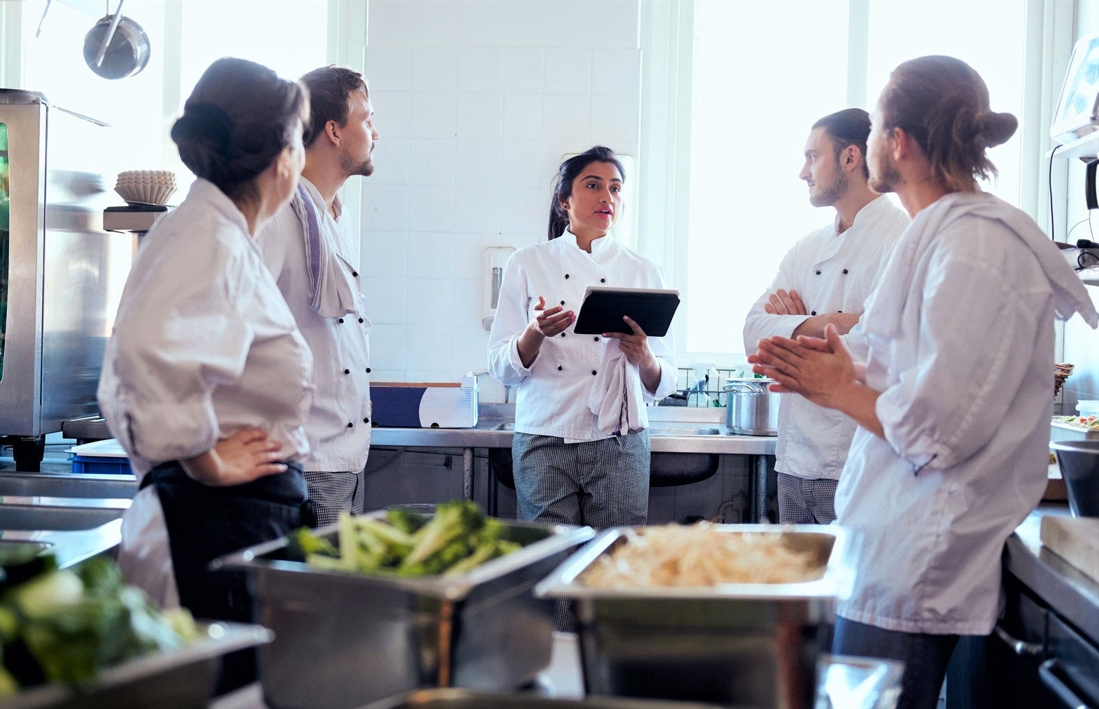 kitchen staff communicating with one another to work out to reduce food costs