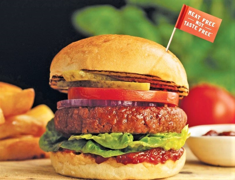 succulent plant-based meat burger with sign saying meat-free not taste-free