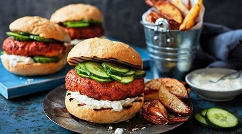 pair of delicious plant-based burgers with potato wedges