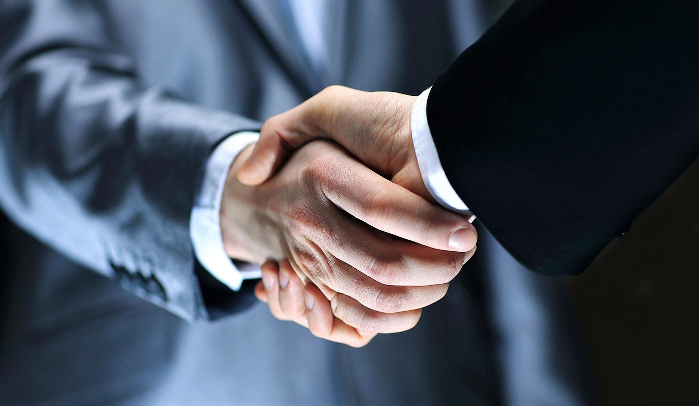 professional businessmen shaking hands to consolidate new restaurant opening