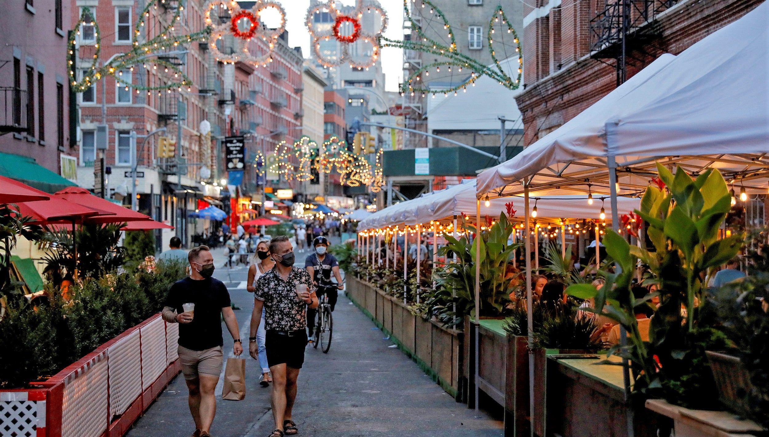 couple walk through outdoor dining area of restaurants during covid