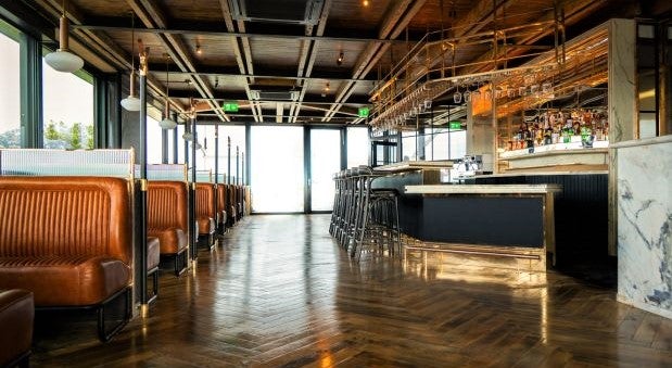 low angle shot of restaurant floor with sunlight streaming through large window