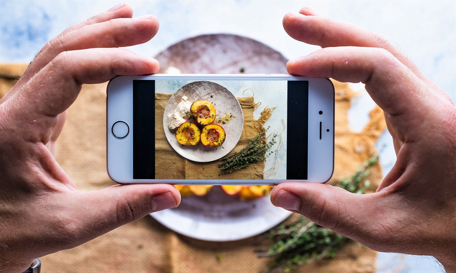 man uses iphone to photograph dish to promote favorite restaurant