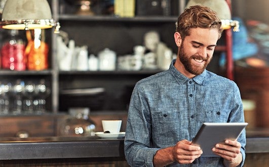 trendy young restaurant manager writing menu for new business